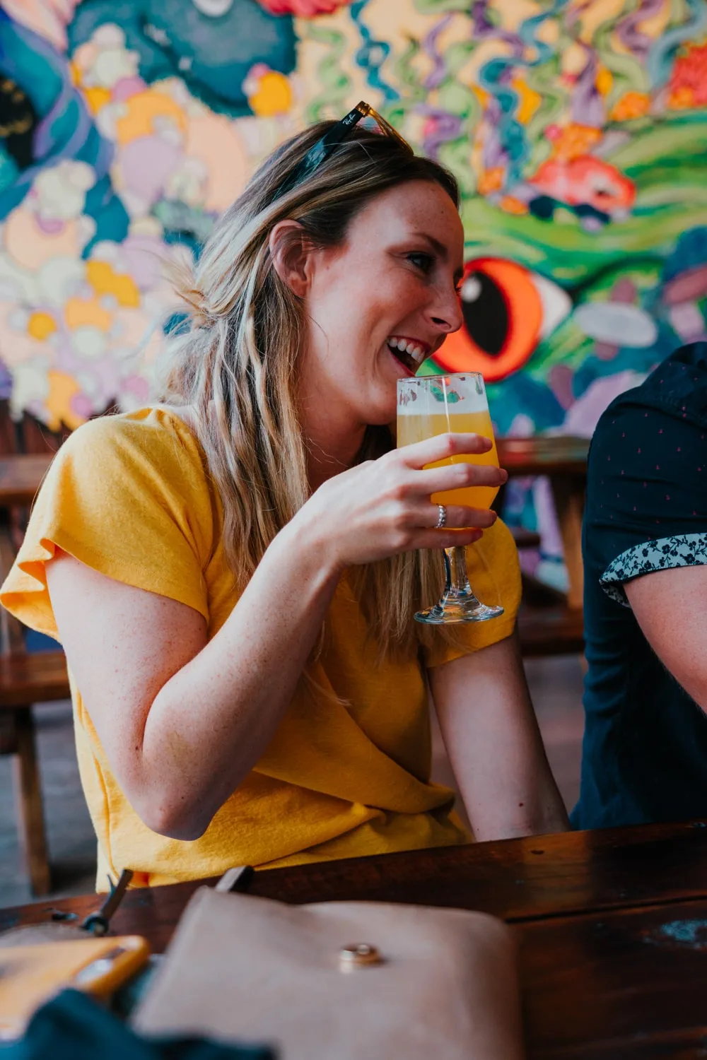 Woman laughing holding sour beer at Little Animals Brewery in Johnson City TN