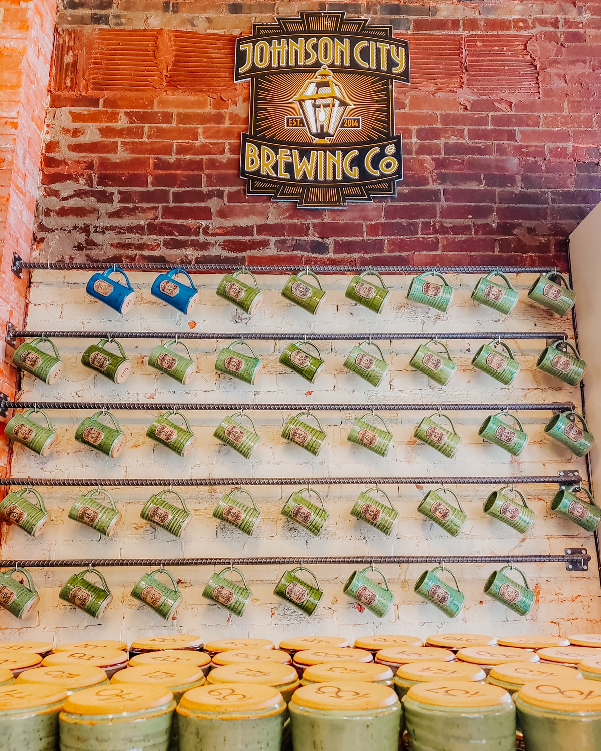 Wall of Johnson City Brewing Company mugs