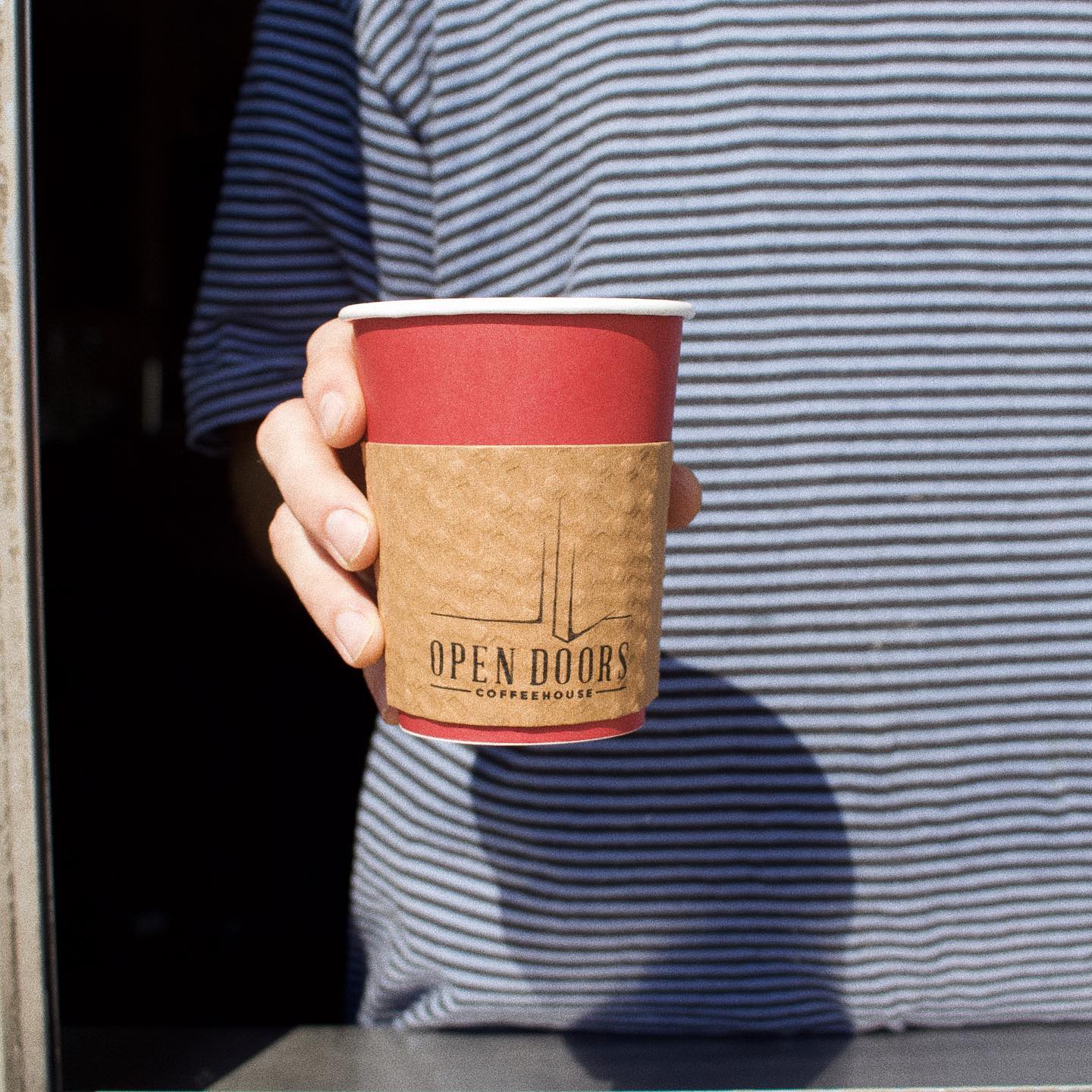 Red open doors coffeehouse to-go coffee cup