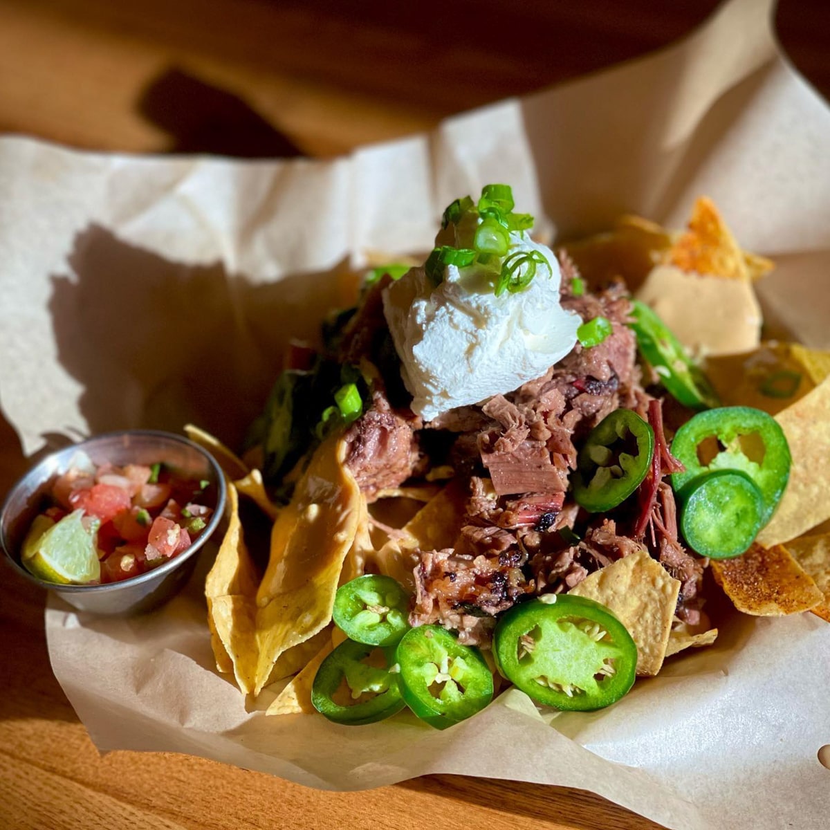 Beef Brisket Nachos with sour cream and jalapeños at Southern Craft BBQ