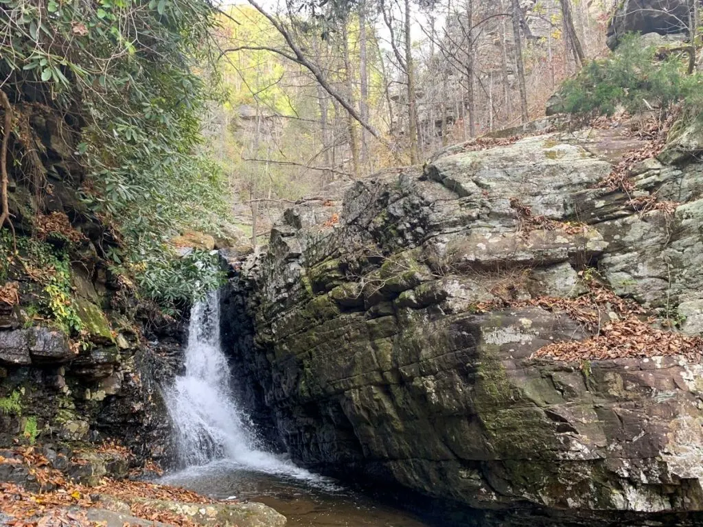 small waterfall between rocks at rock creek falls tn
