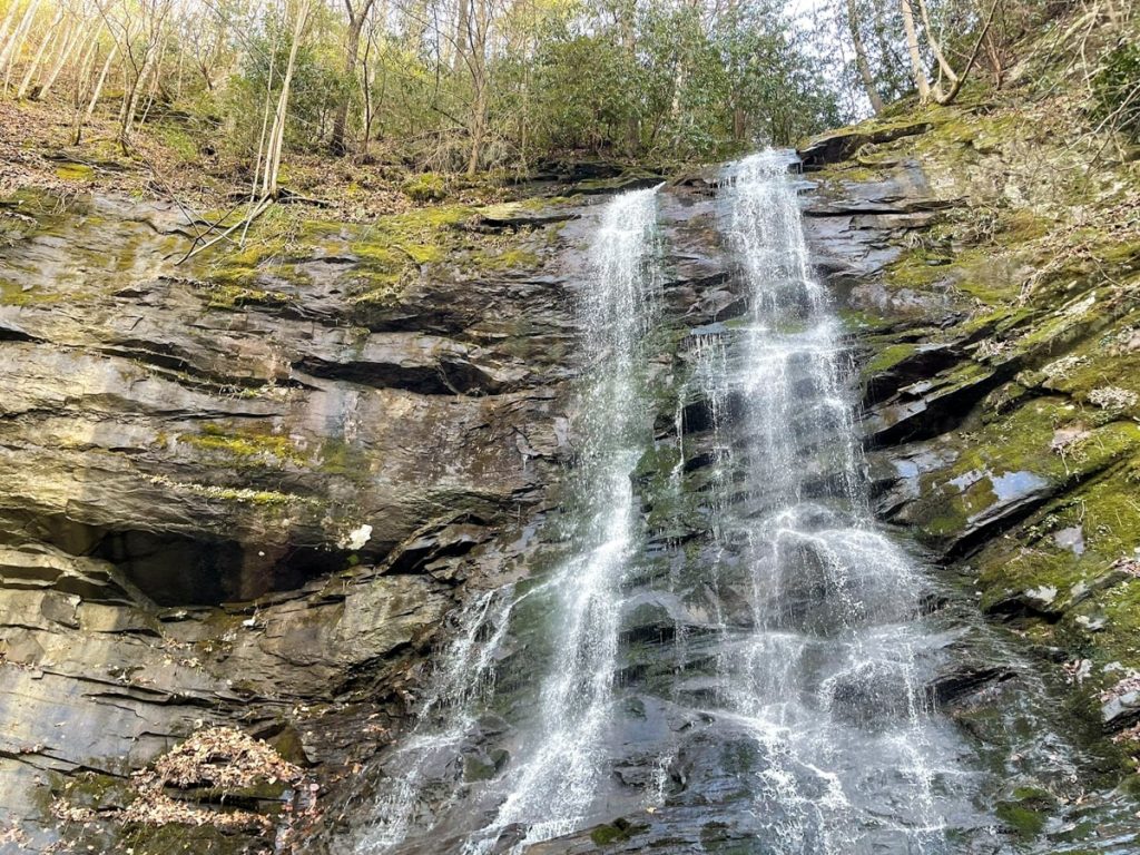 wispy waterfall cascades down rocks at sill branch falls in east tennessee