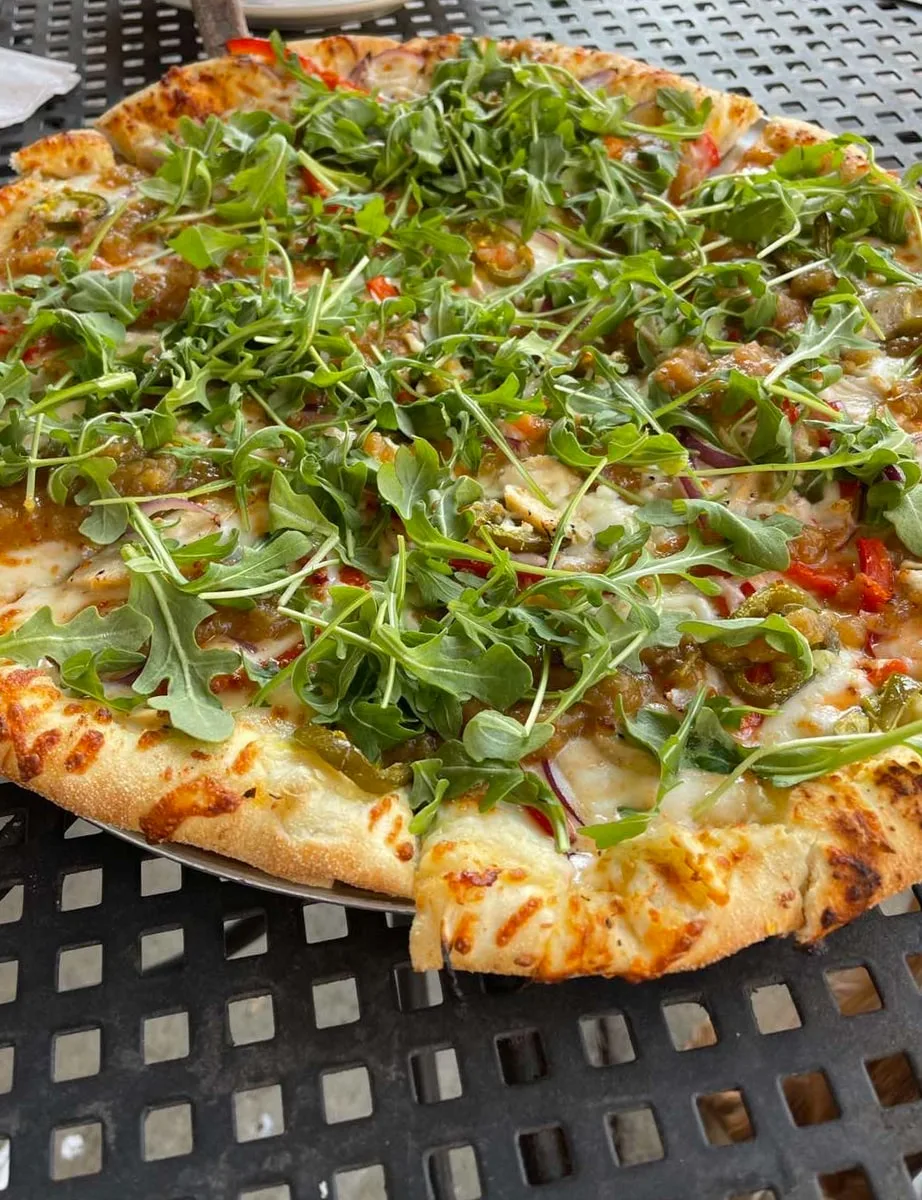 Thai Pie with roasted chicken, arugula, jalapeños, and onion at Main Street Pizza Co