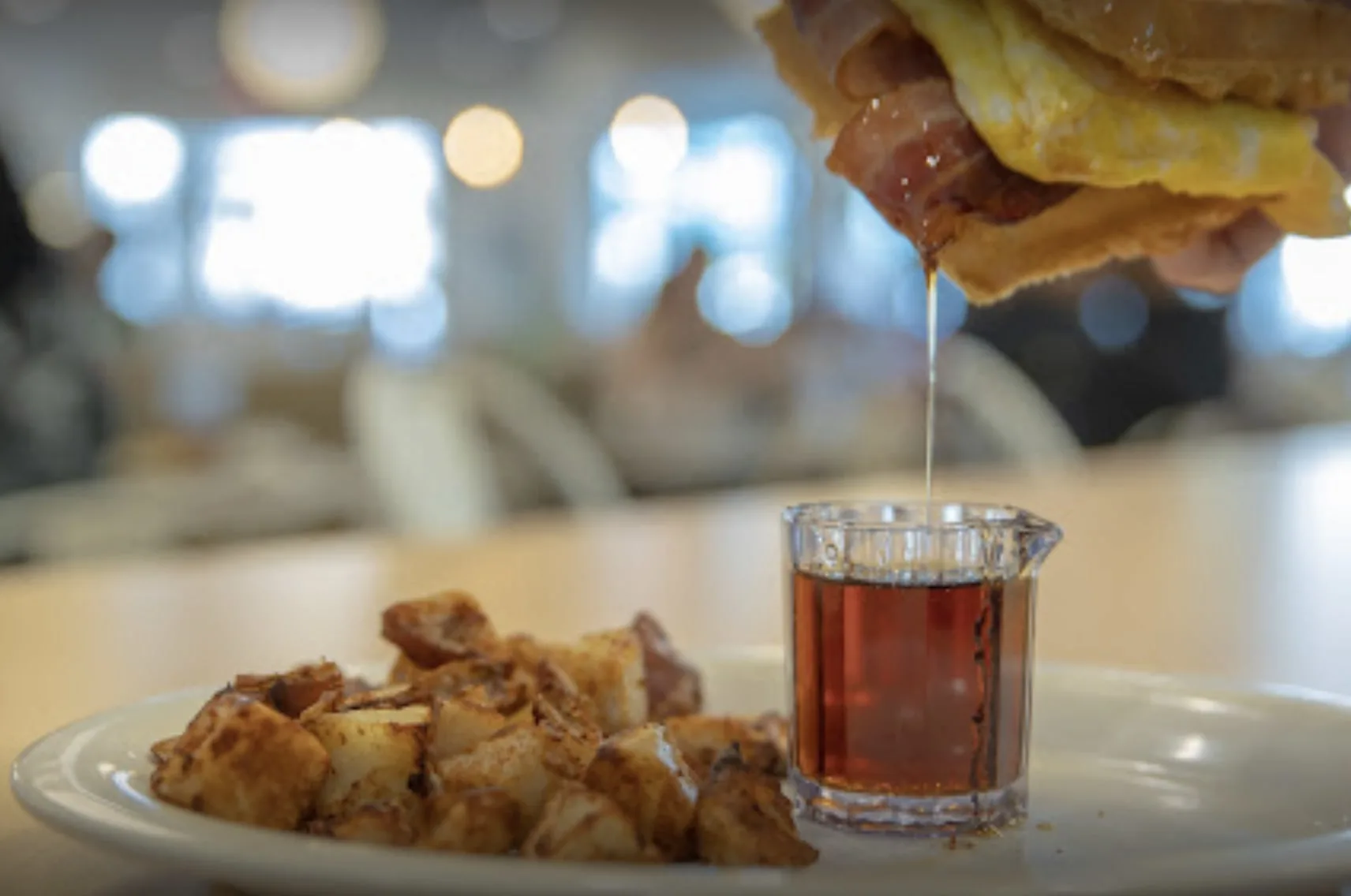 breakfast sandwich dipped in maple syrup