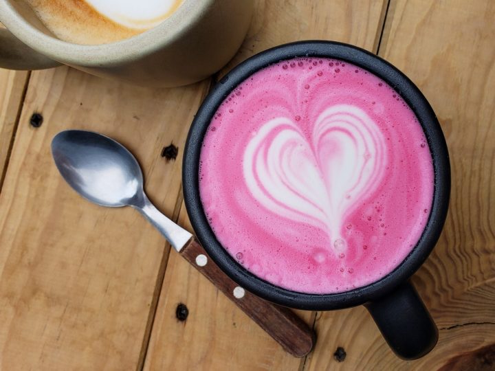 Pink beet latte with white foam heart