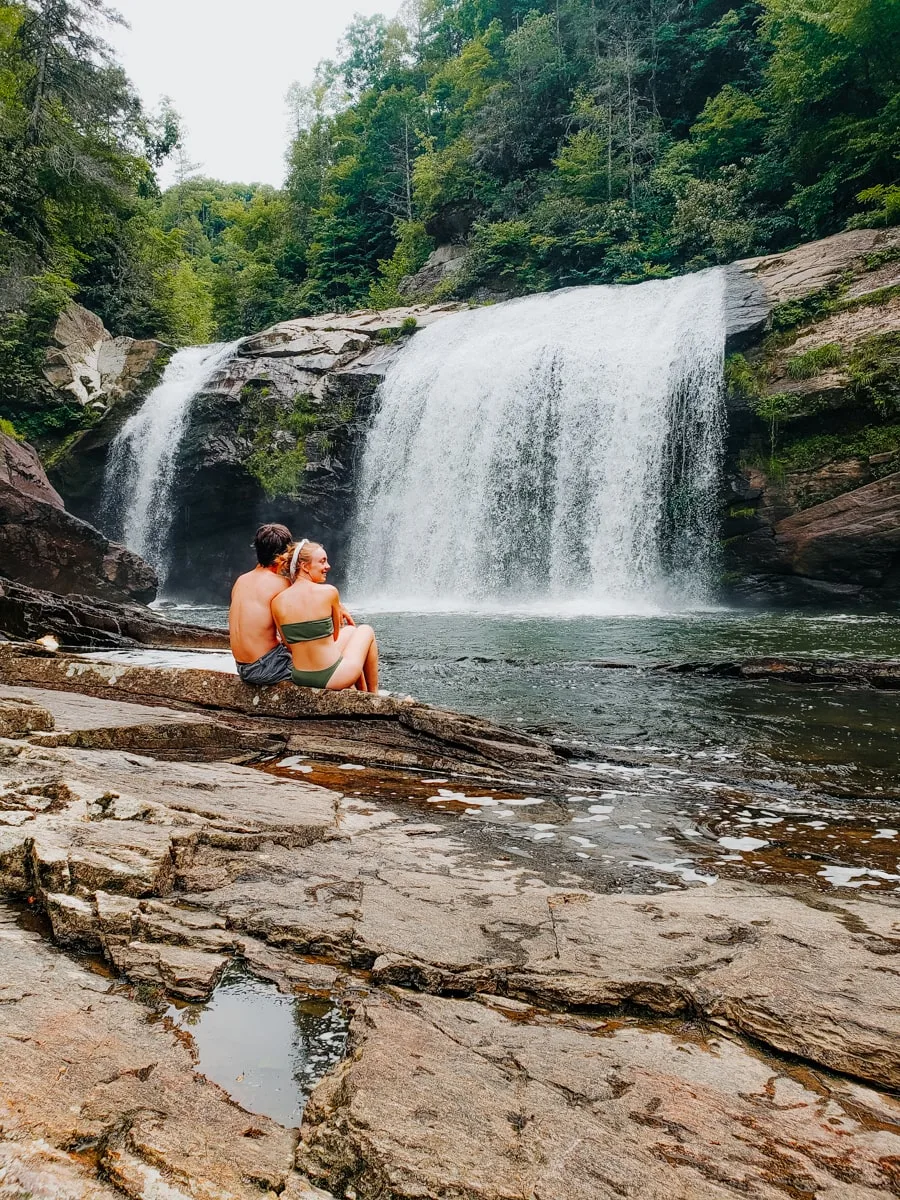 Couple sits on rock at Compression Waterfall in East TN
