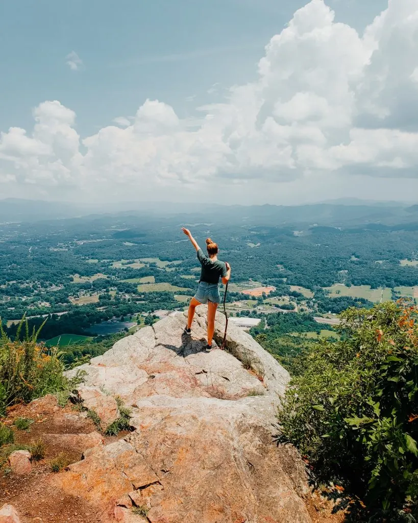 Female hiker standing at White Rock overlook in Buffalo Mountain Park in Johnson City TN