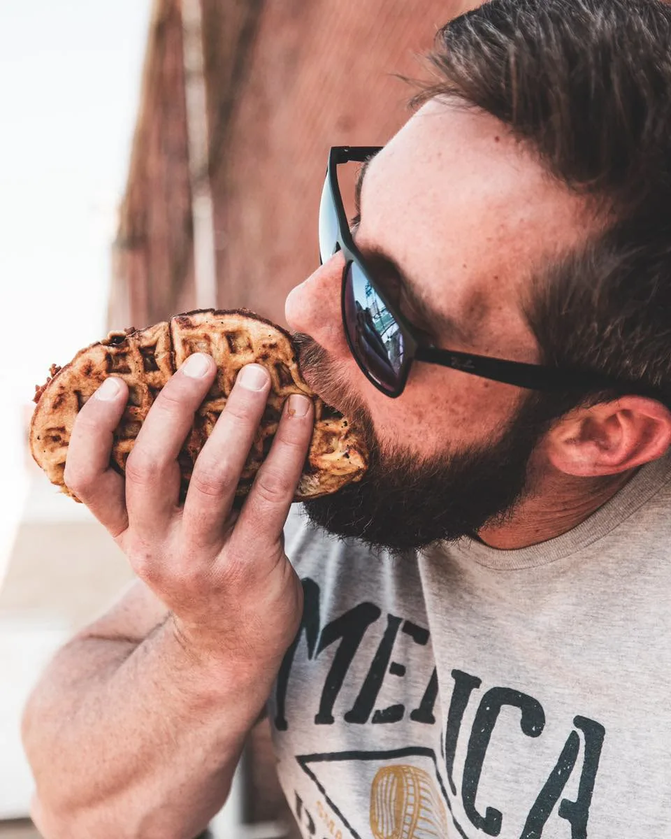man eating a waffle taco from the project waffle food truck 