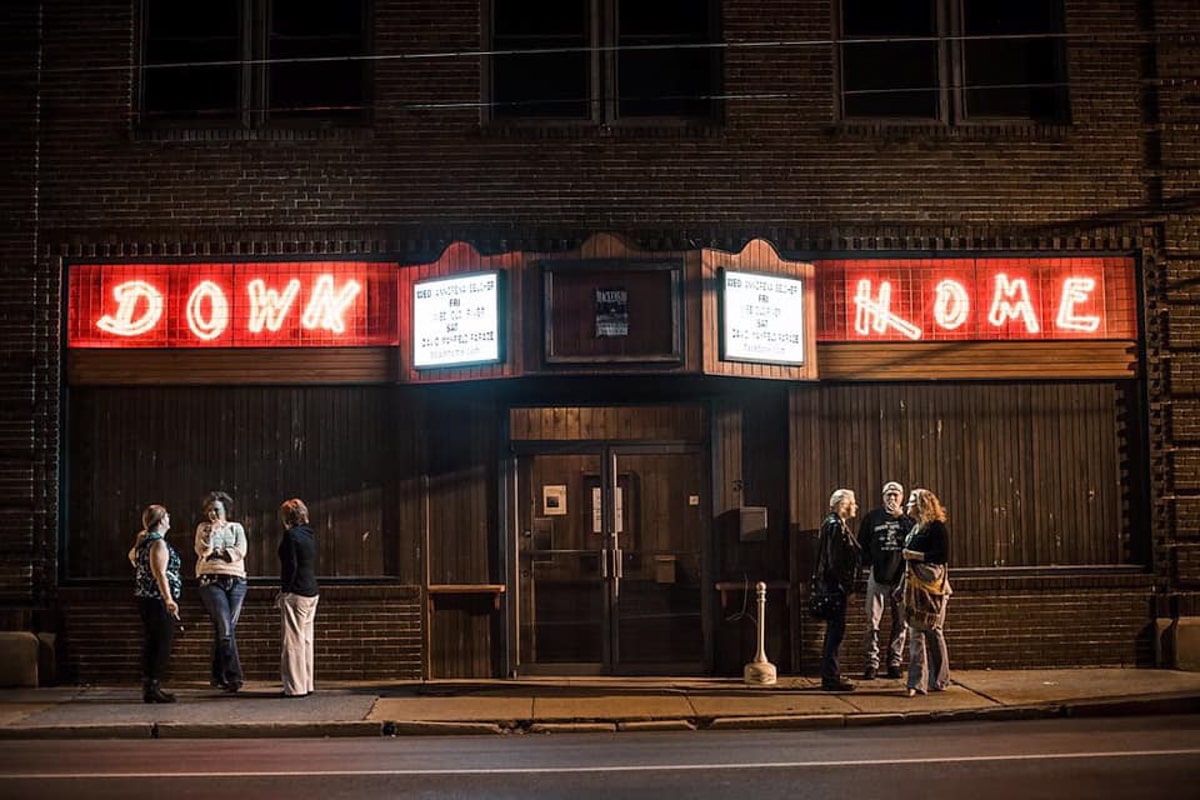 people standing outside of Down Home music venue 