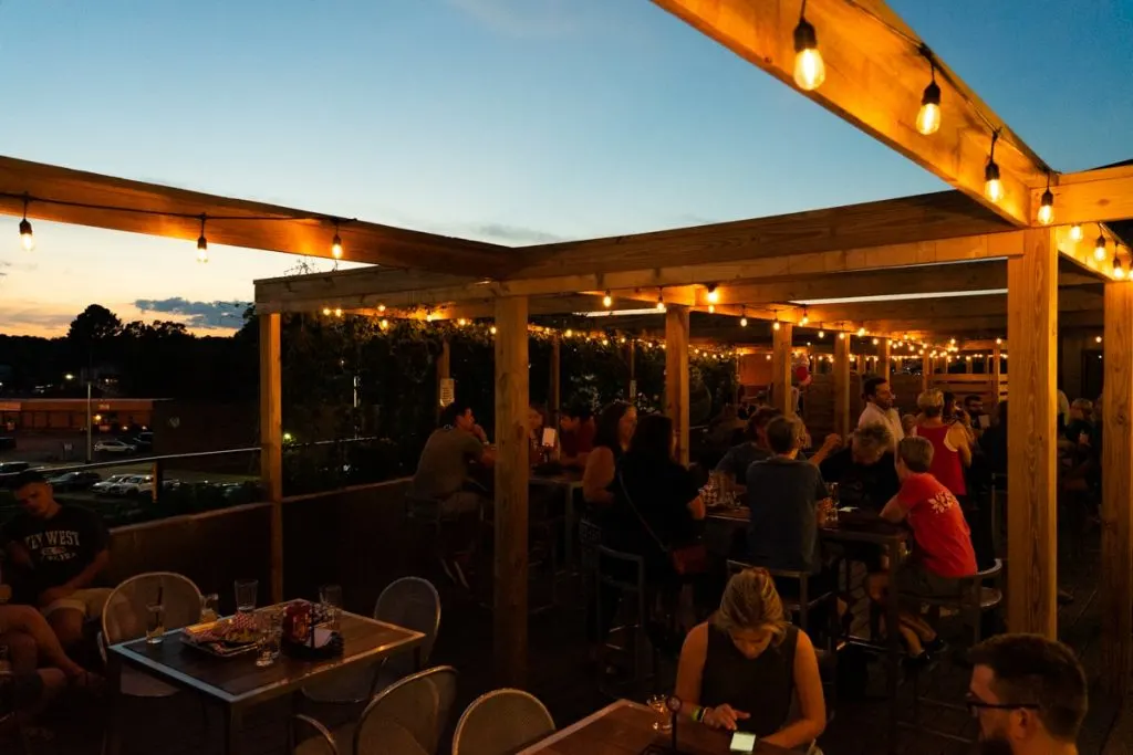 Crowd of people on rooftop bar at sunset in Johnson City TN