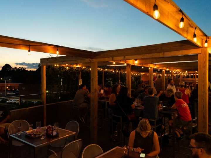 Crowd of people on rooftop bar at sunset in Johnson City TN
