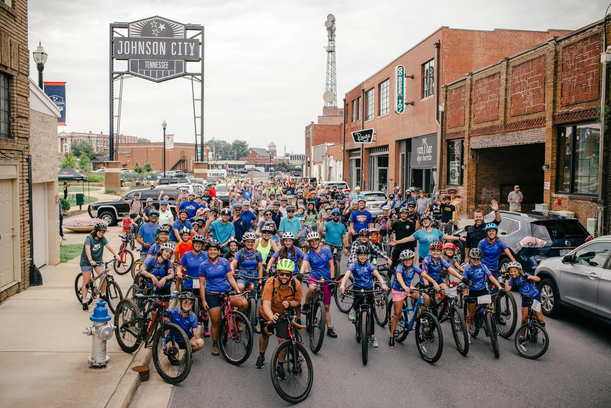 people riding bikes in downtown johnson city tn for the taco trek 