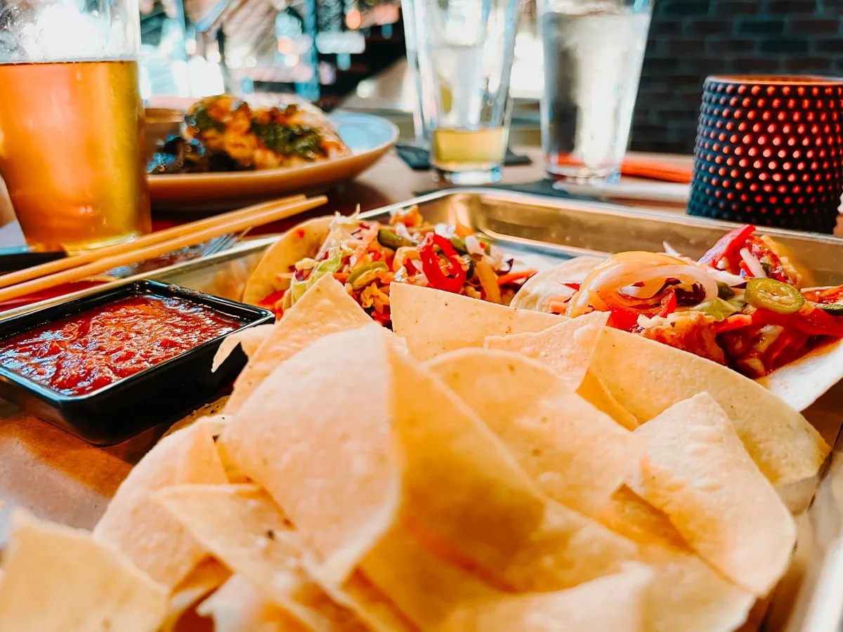 Platter of nachos and Asian Mexican fusion tacos