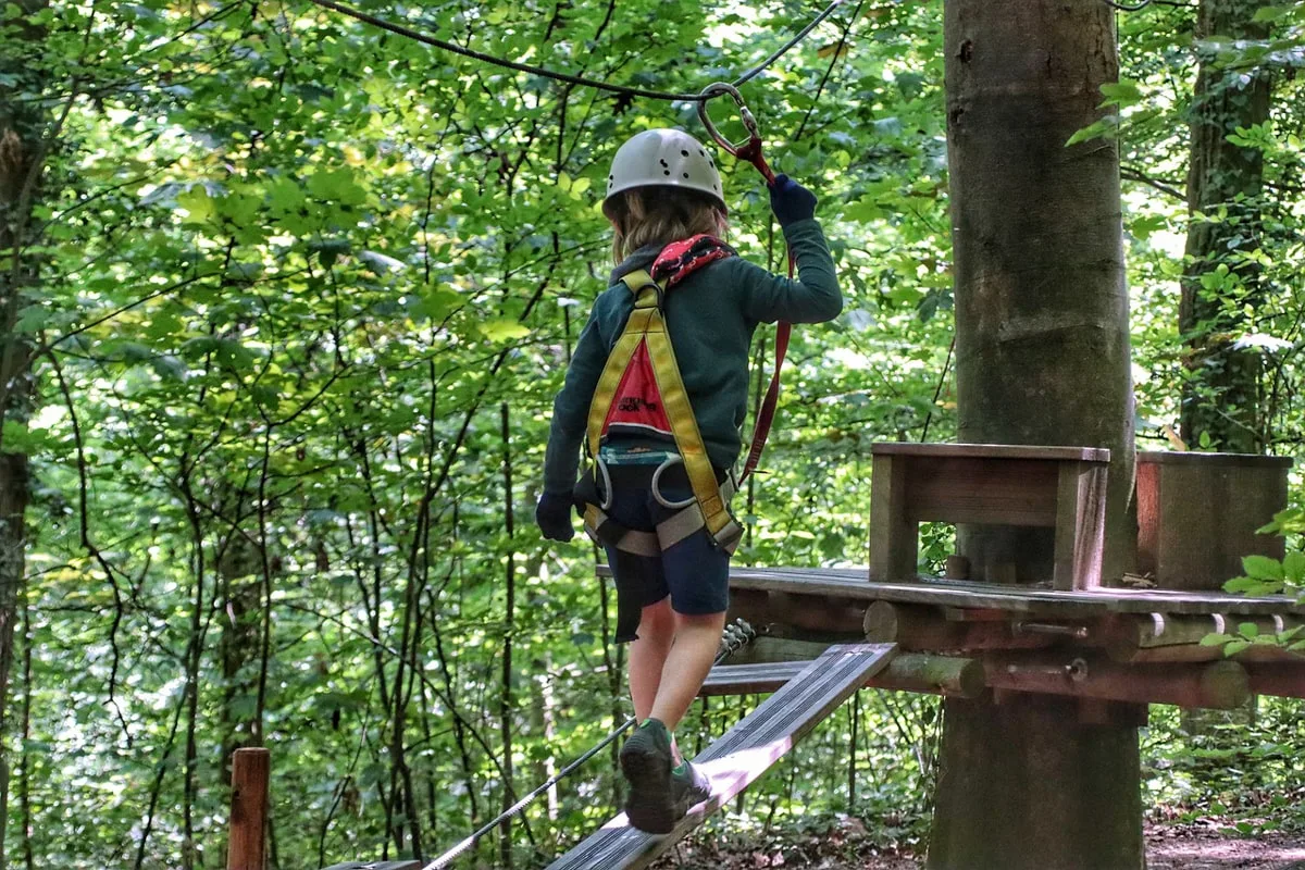 girl about to go ziplining through the trees 
