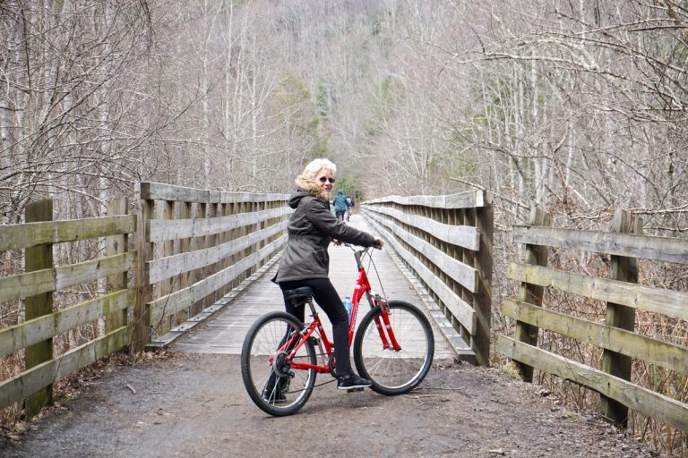 Woman on red bike biking the Virginia Creeper Trail