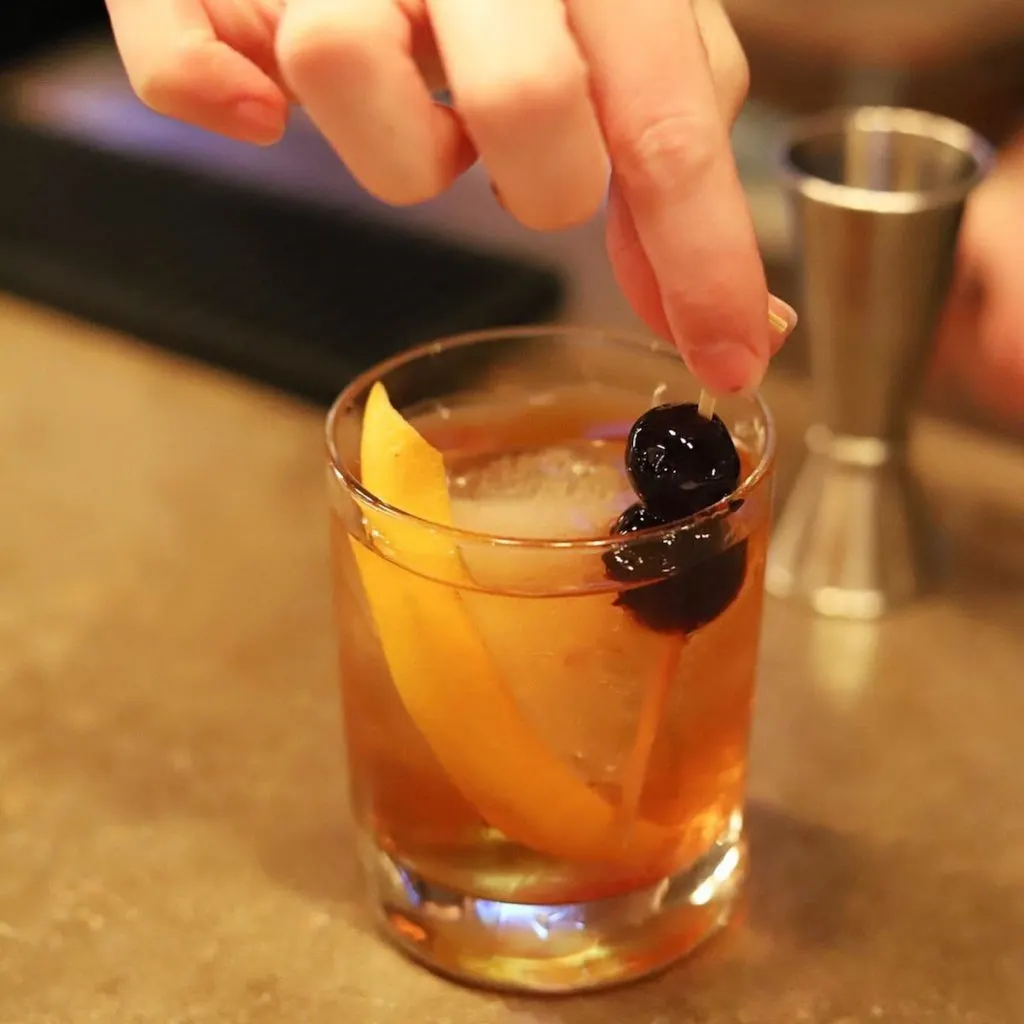 Old fashioned with bourbon and cherries