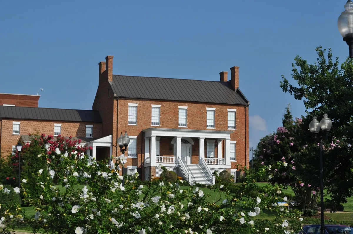 Exterior of the Dickson-Williams Mansion with flowers and greenery 