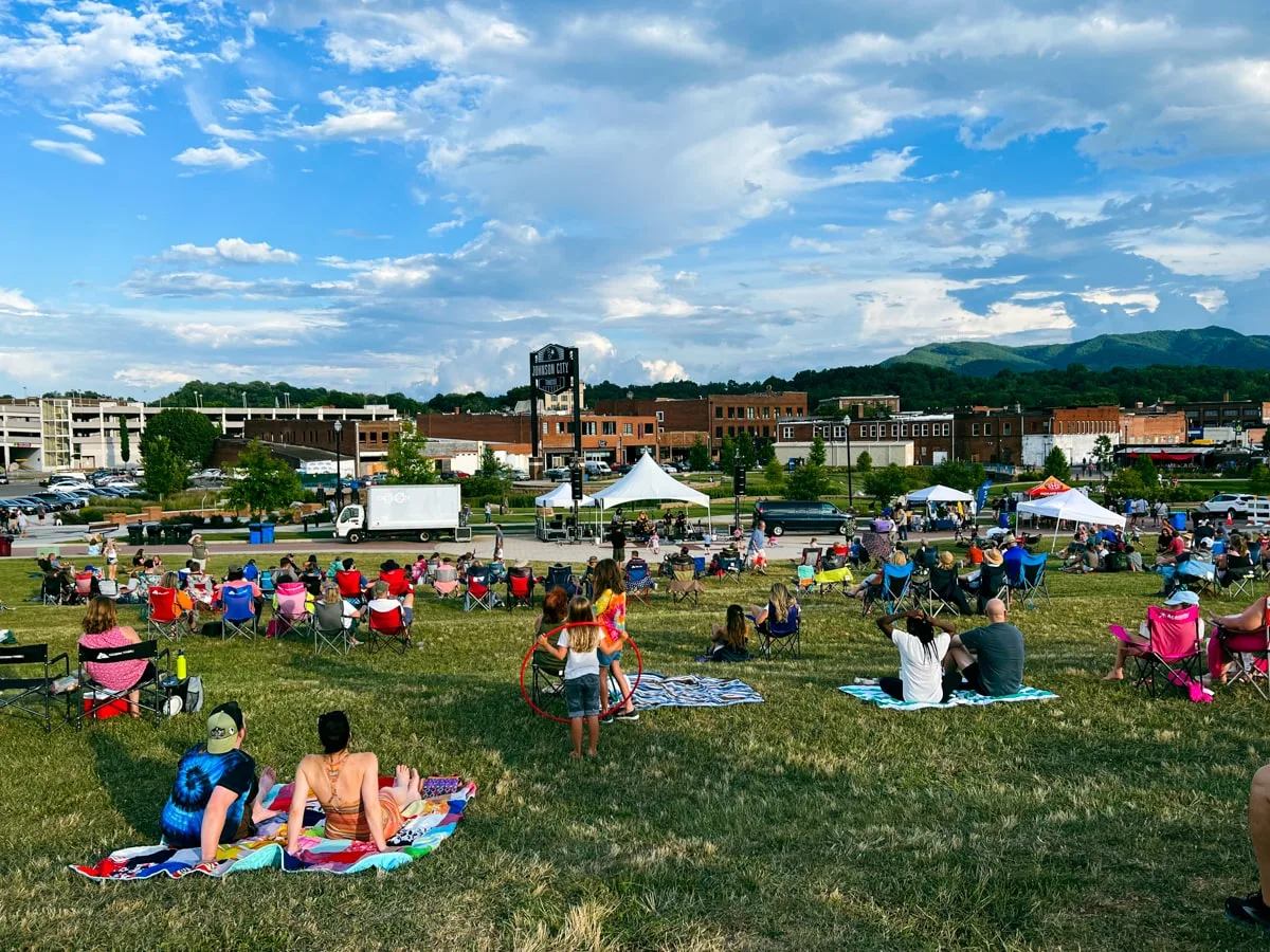 People sitting on the lawn at King Commons park in downtown Johnson City listening to Music at the Fridays After Five Event