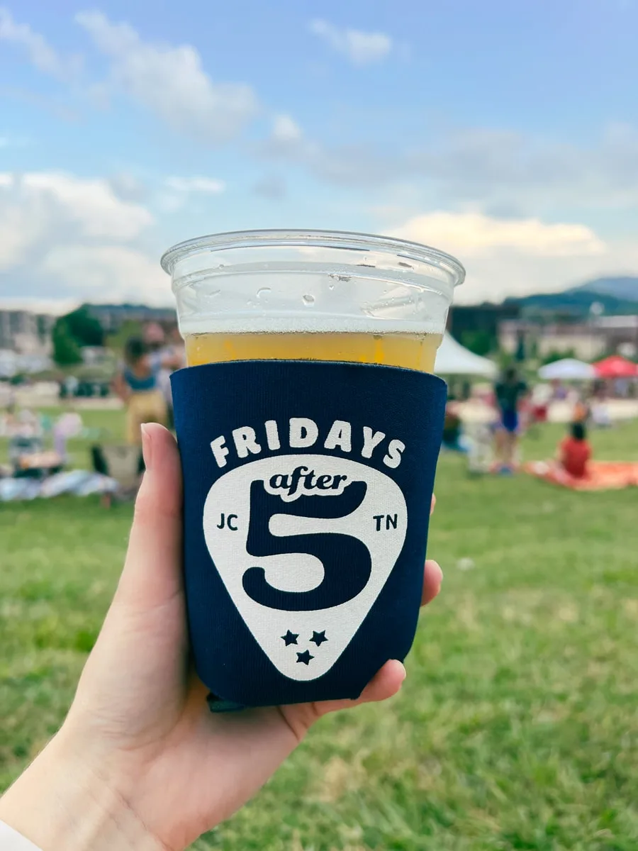 Pint of beer with a Fridays After 5 coozie. 