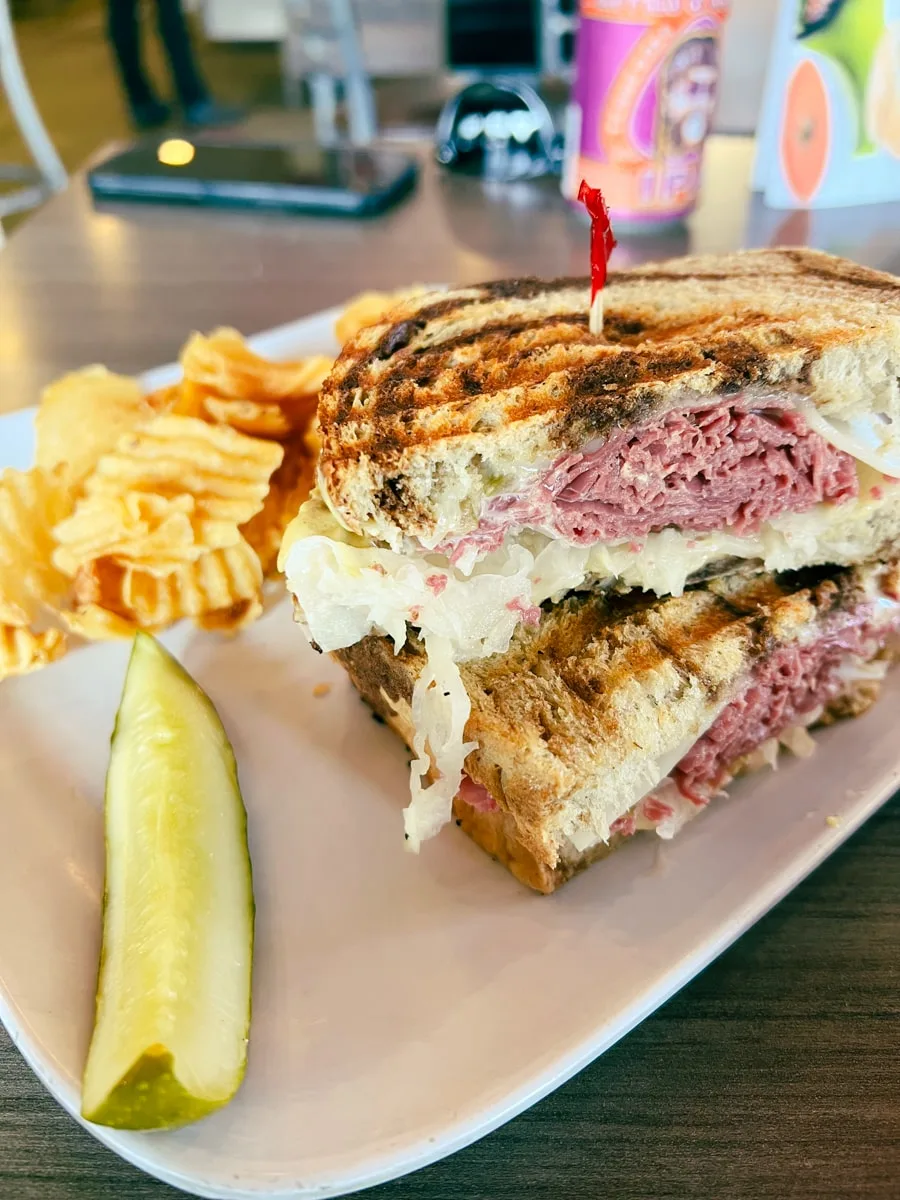 Corned beef Reuben sandwich with chips and a pickle at the RedBud Deli in Morristown