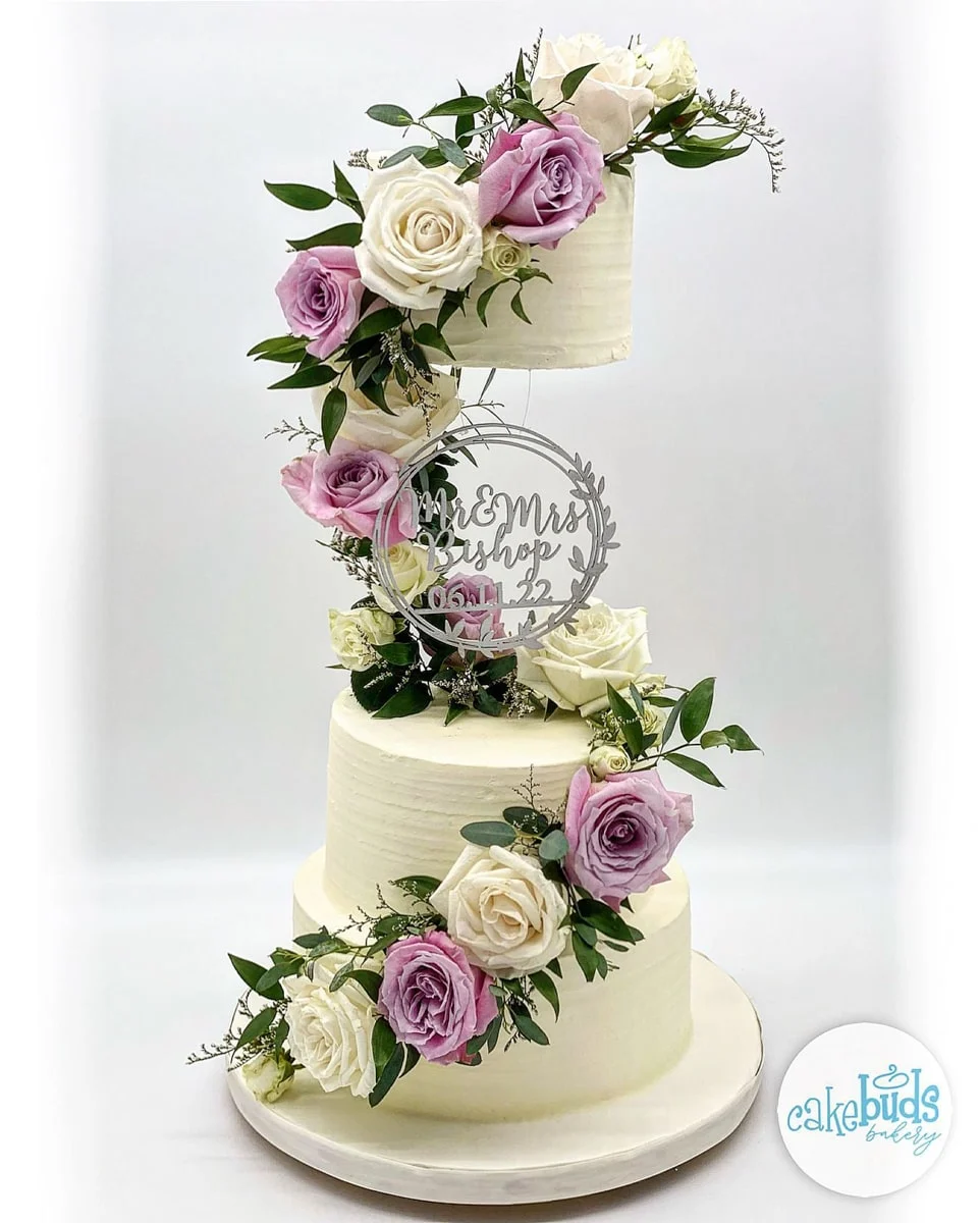 Wedding Cake with purple and white flowers from CakeBuds Bakery