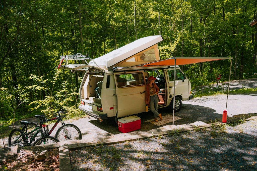Westfalia campervan with bicycles and gear set up at campsite at Watauga Lake campgrounds in Tennessee