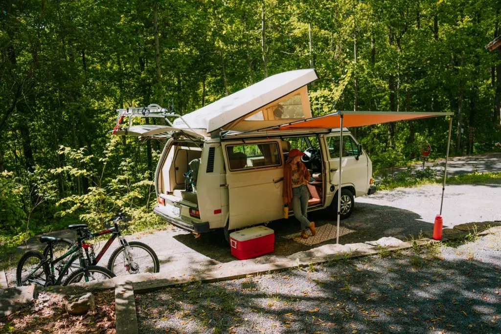 Westfalia campervan with bicycles and gear set up at campsite at Watauga Lake campgrounds in Tennessee