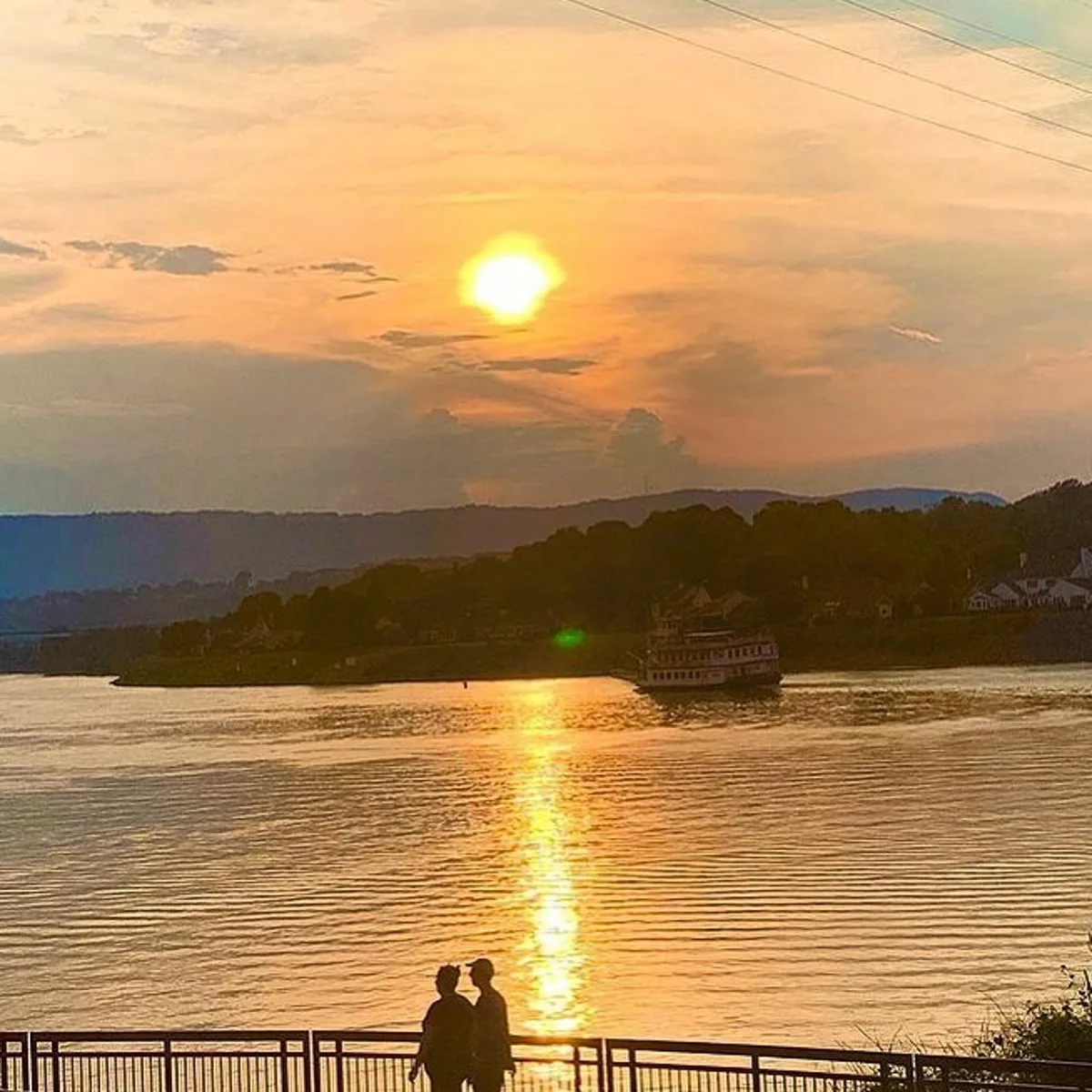 People walking along the Tennessee River with the Southern Belle in the background