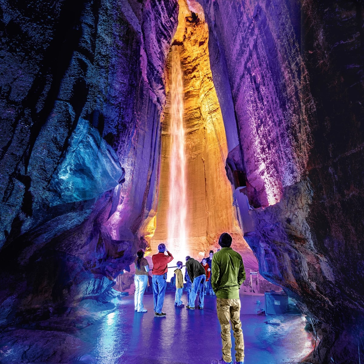 Colorful Ruby Falls with people gazing up