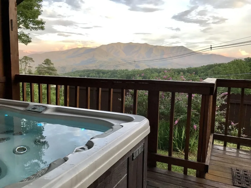 hot tub overlooking the smoky mountains at a cozy cabin