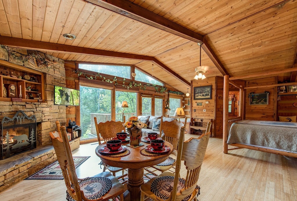 rustic charm cabin interior with fireplace and views of the smoky mountains with large windows