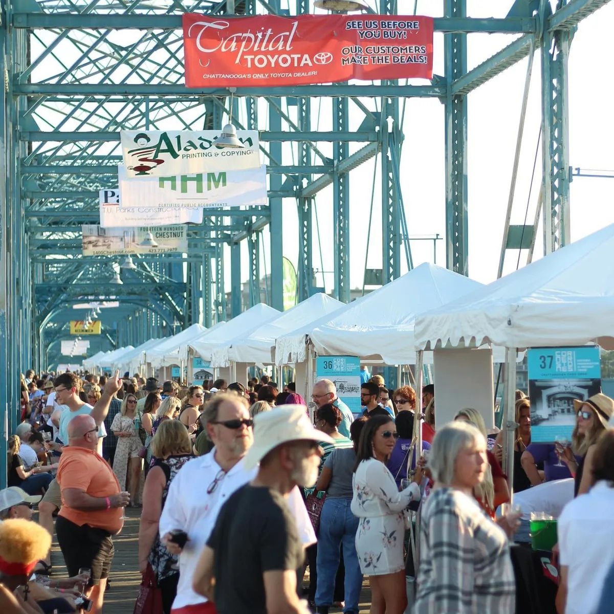 people attending the wine over water event on the walnut street bridge 