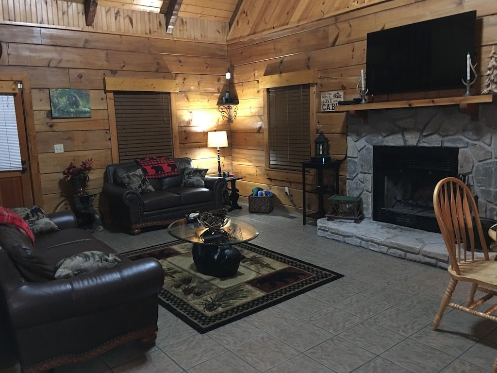 cozy cabin with leather couches and fireplace