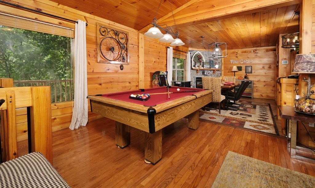 a pool table and seating inside a wooden cabin rental