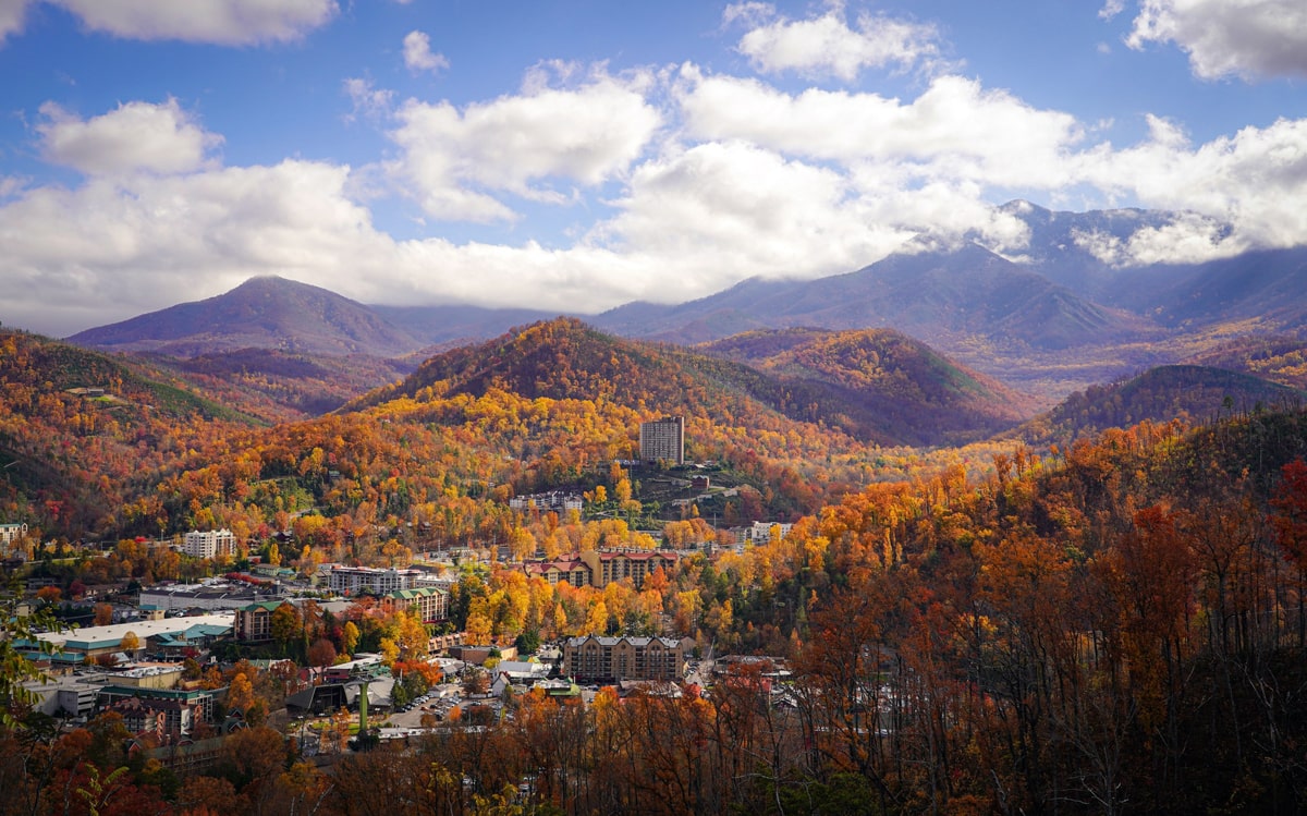 The city of Gatlinburg surrrounded by fall foliage mountains