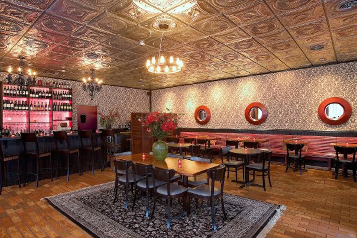 Cafe Lola interior with wallpaper walls and red accent pieces