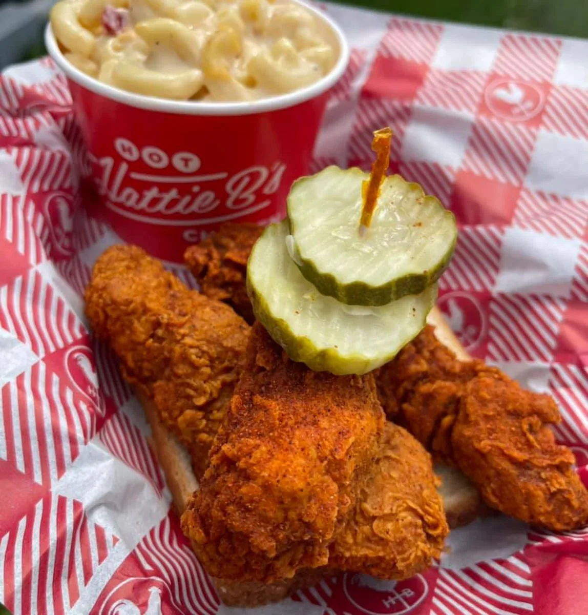 Hot chicken on white bread with pickles with mac and cheese at Hattie B's Hot Chicken