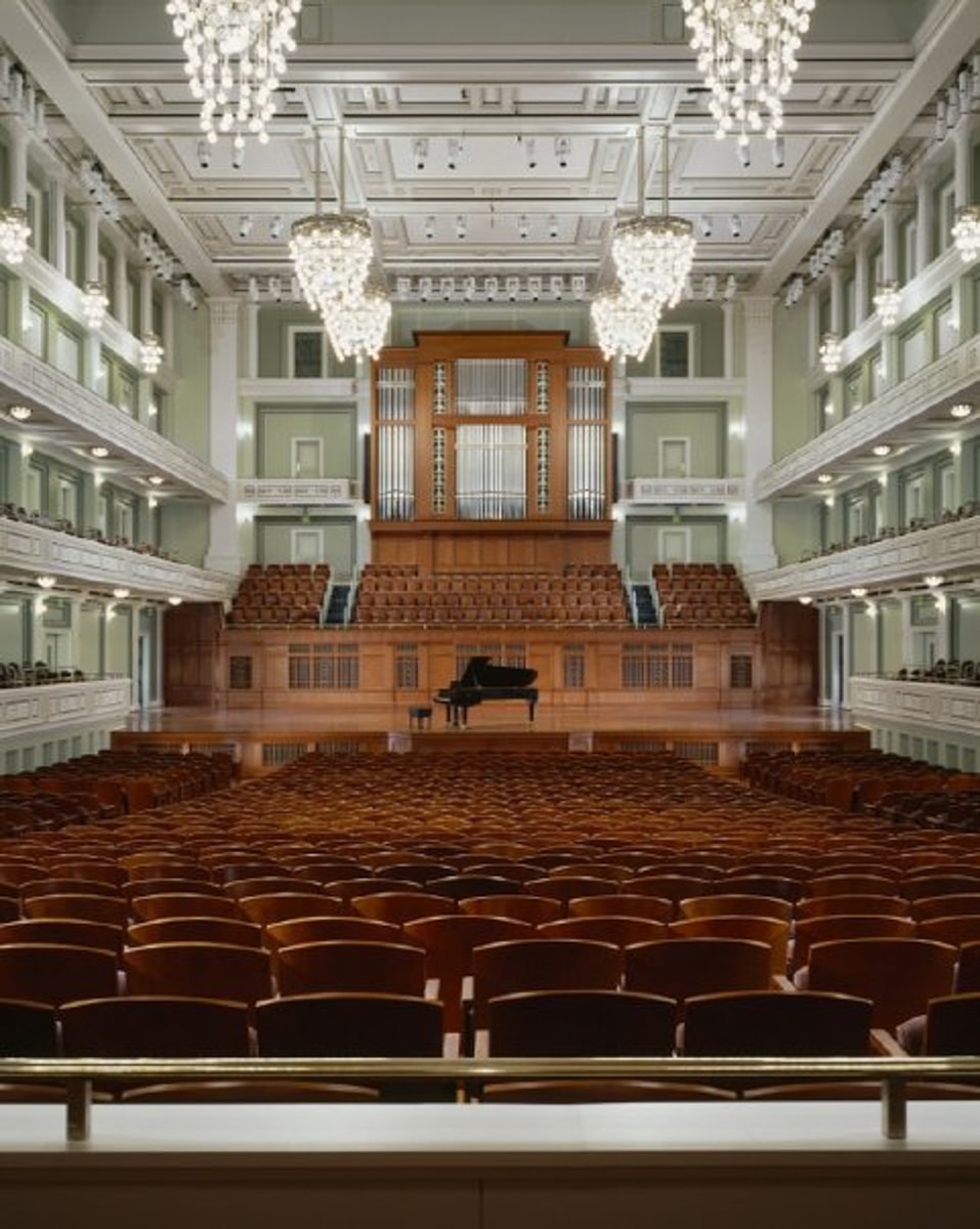 inside of schermerhorn symphony center with auditorium seating and a grand piano on stage