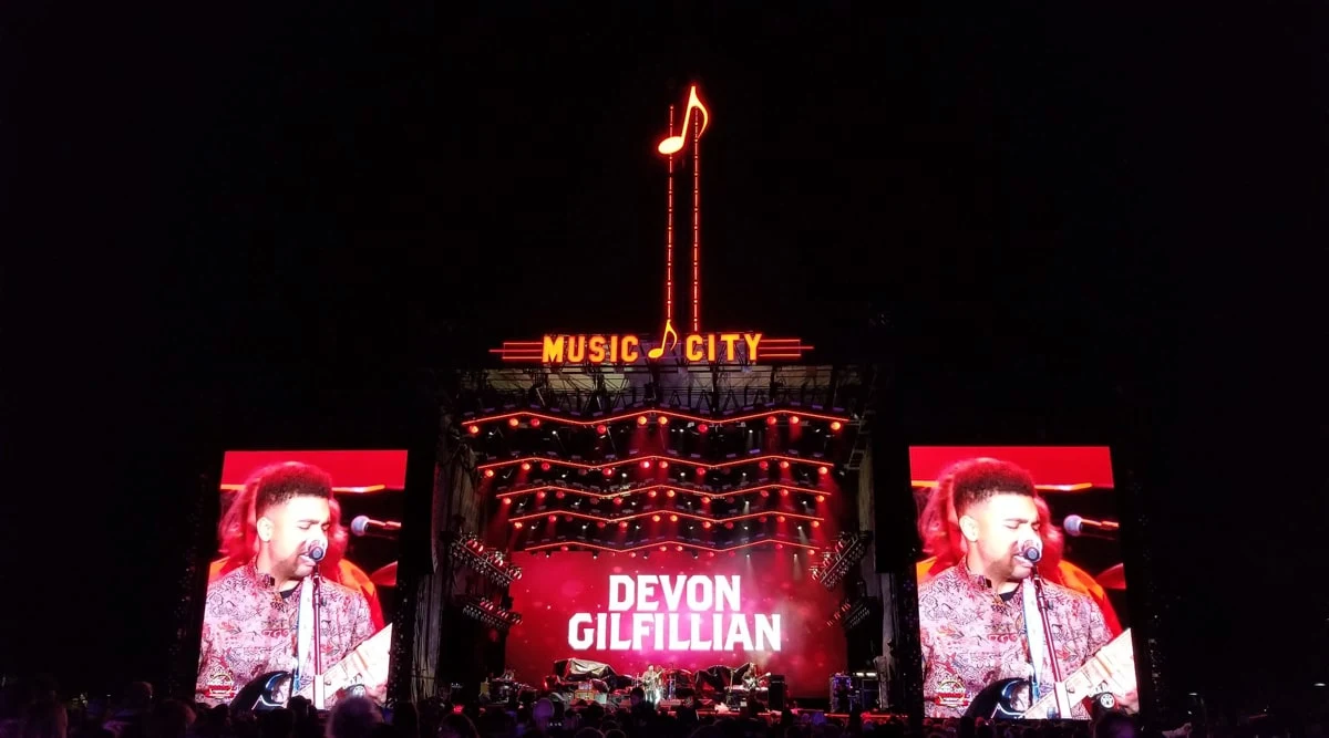 a stage in downtown at night with singer and music note about to drop for new years celebration in nashville 