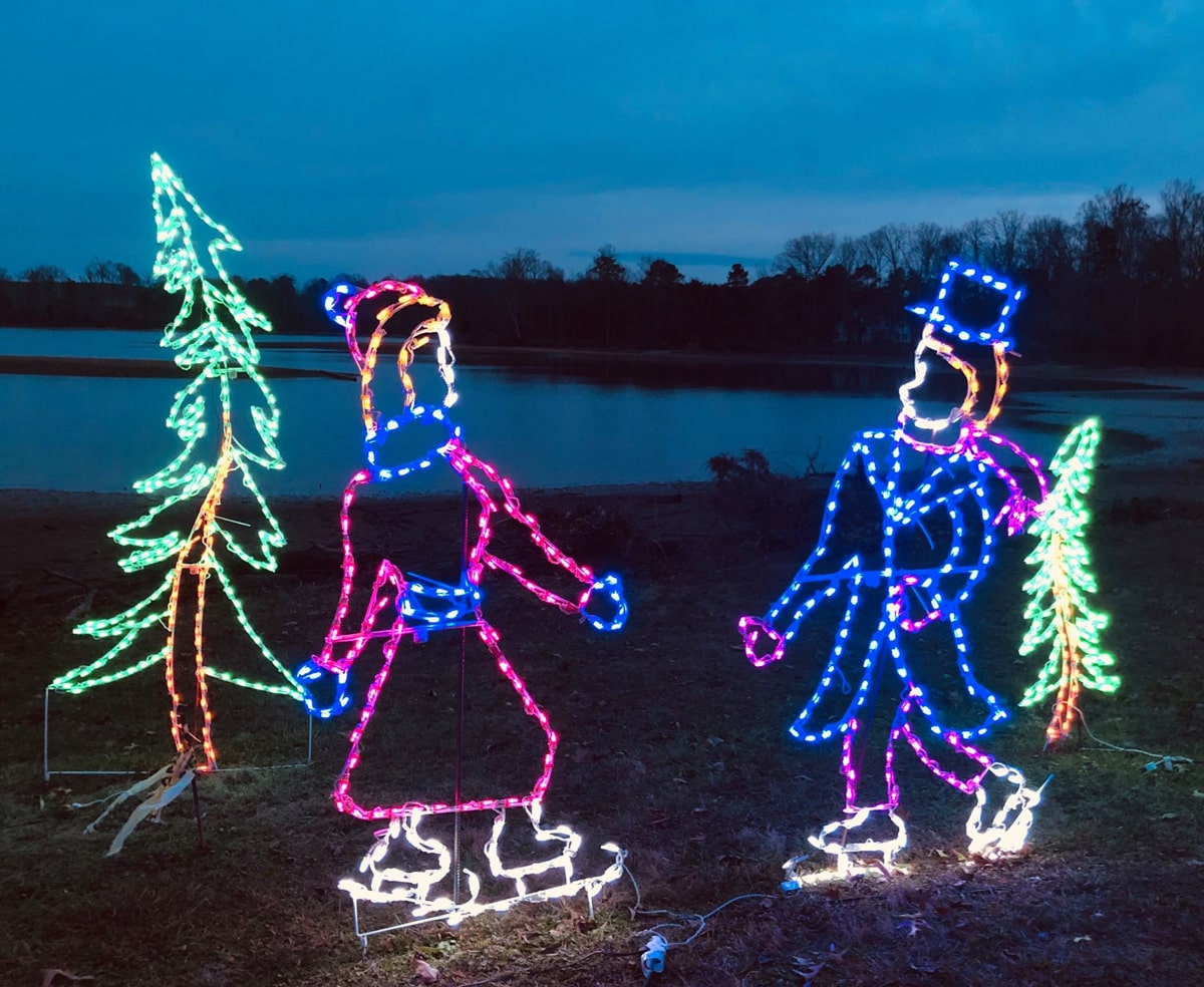 Christmas lights of a man and woman skating at The Cove at Concord Park. 