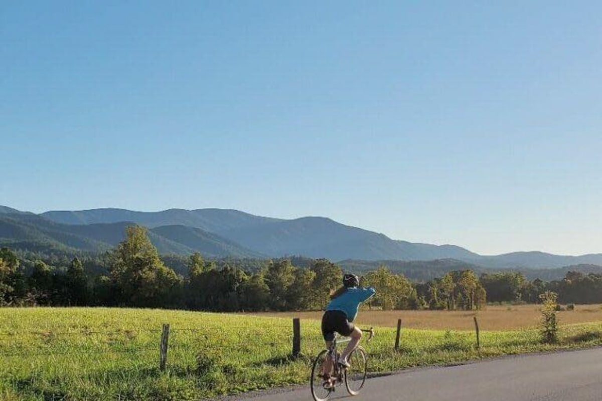 Girl riding bike on the scenic loop at Cades Cove in the Smoky Mountains
