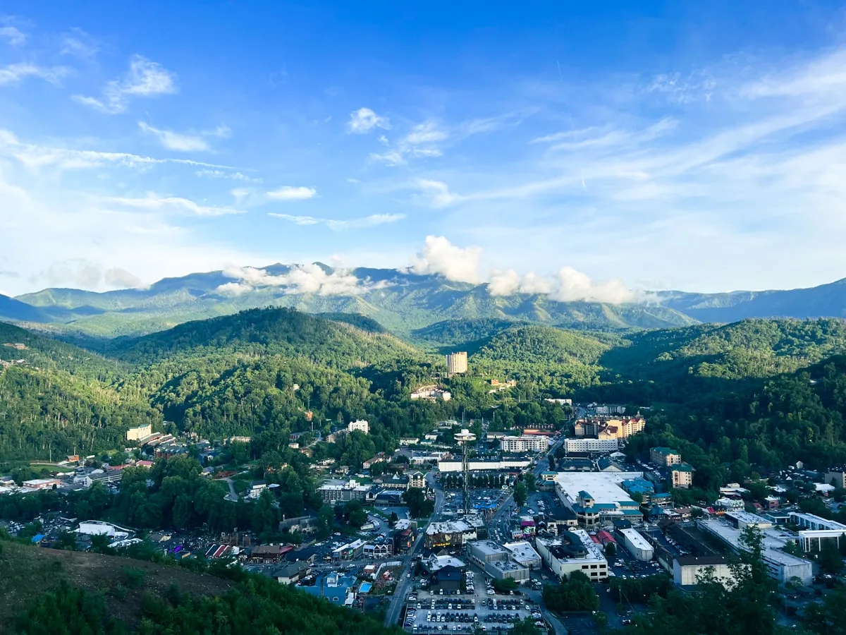 View of Gatlinburg TN from the Gatlinburg Sky Bridge with Blue skies and mountains in the background