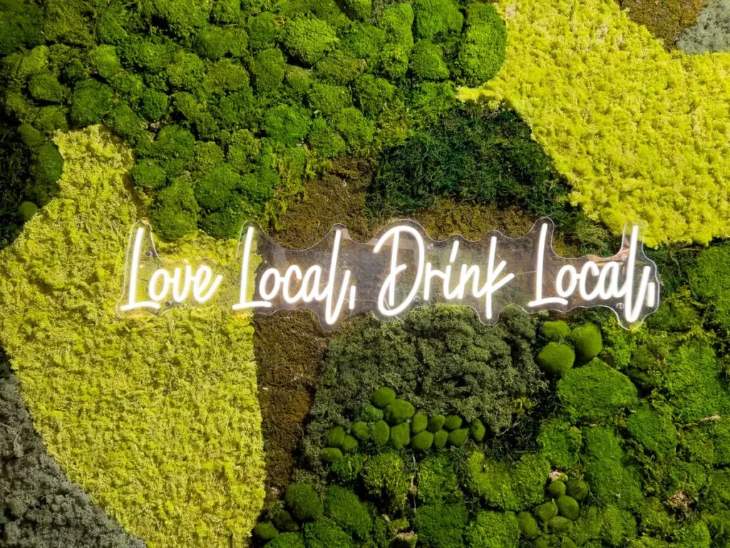 Mossy mural with words "Love Local, Drink Local"