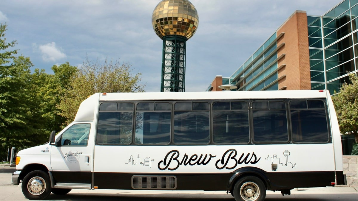 Brew Bus Knoxville bus tour parked in front of the sunsphere in Knoxville TN 
