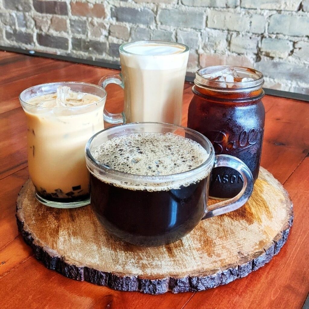 Coffees such as an americano, ice coffee, latte from bristol bagel and bakery coffee shop bristol tn