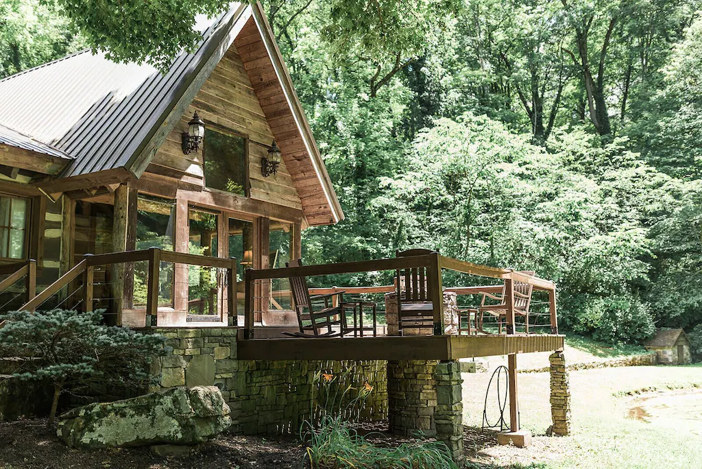 Historic Civil-era log cabin with porch and stone work.