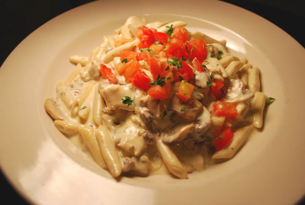 creamy pasta topped with fresh tomatoes and herbs at the black olive in downtown johnson city tn