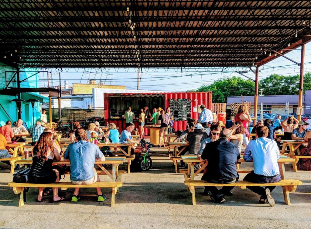 People eating at a food truck park in Knoxville TN. Central Filling Station