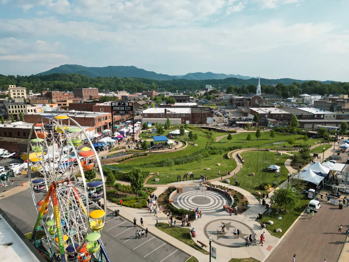 blue plum festival in king commons park in downtown johnson city with a ferris wheel, vendors, food trucks, and live music