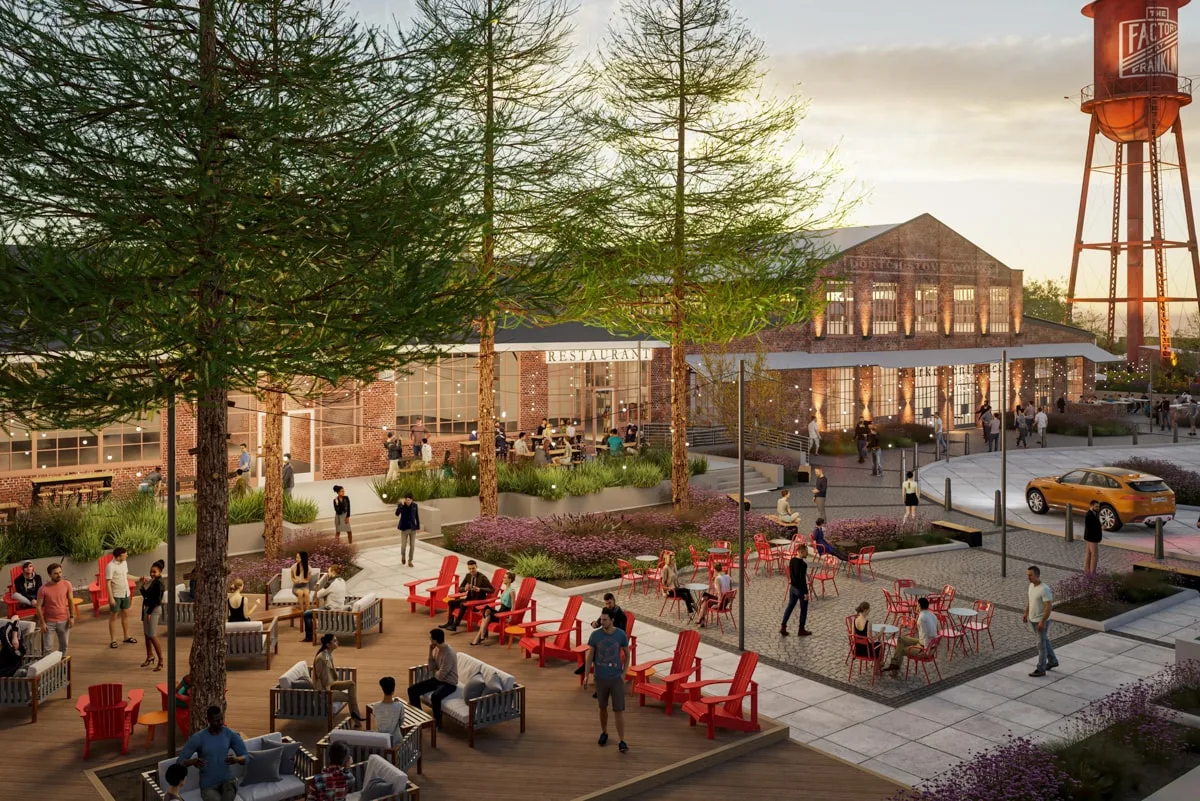 The Factory at Franklin outdoor area with tables and chair and the Factory of Franklin water tower in the background